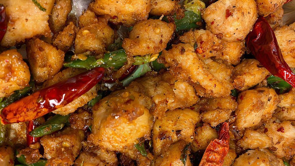 5. Kung Pao Chicken · Rice served with fried fish with chili pepper.
