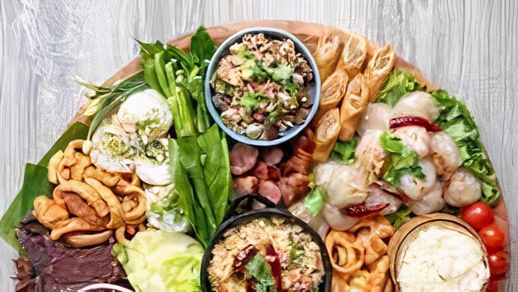 Lao Appetizer Platter · Chicken Lao style fried spring rolls, Lao sausages, and Kao Nam Tod. Served with vermicelli noodles, onions, green leaves, and Lao dipping sauce.