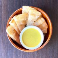 Crispy Roti with Curry Sauce · Crispy roti pancakes. Served with yellow curry or red curry sauce.