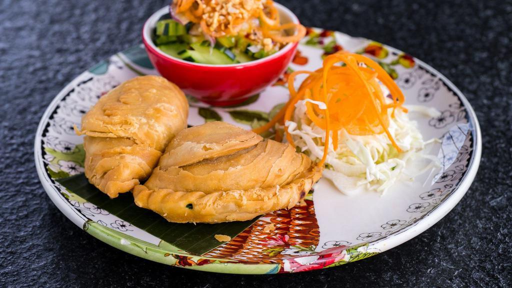 Vegetarian Spiral Curry Puffs · crispy pastry (3) stuffed with potatoes and vegetables served with cucumber salad