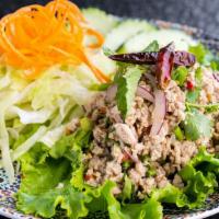 Chicken Larb Salad (Gluten-Free) · Minced chicken salad mixed with red onions, mint, cilantro, lime juice, and ground roasted r...