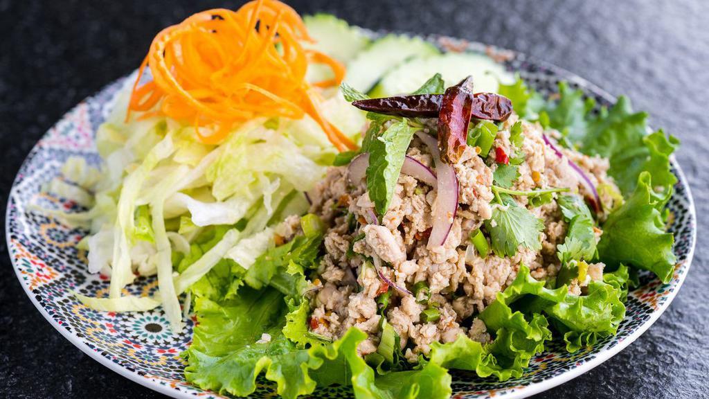 Chicken Larb Salad (Gluten-Free) · Minced chicken salad mixed with red onions, mint, cilantro, lime juice, and ground roasted rice.