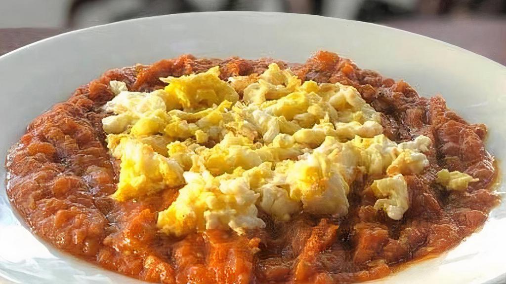 Mirza Ghasemi · A combination of tomatoes, garlic, mashed grilled eggplants, and eggs.