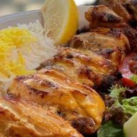 Jujeh with Bone Kabob · Delicious marinated charbroiled cornish hen topped with saffron.