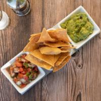 Totopos · Served with house made tortilla chips, fire roasted habanero salsa, tomatillo salsa, guacamo...