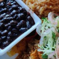 Puerco Pibil  · Anato spiced slow braised pork shoulder, citrus slaw, rice and beans.