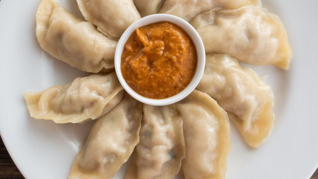 Fried Mo Mo · Fried Dumpling with spices and your choice of vegetables or chicken. Comes with Chili Sauce.