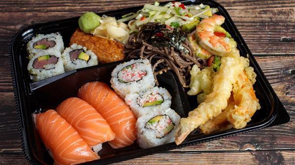 11. Sushi Bento Plate · Nigiri sushi, California rolls, tuna maki, Inari sushi, avocado shrimp, papaya salad, soba noodles, and tempura.
