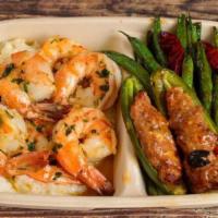 7. Grits & Shrimp Plate · Garlic butter shrimp over grits with sausage stuffed jalapeños and stir-fried green beans.