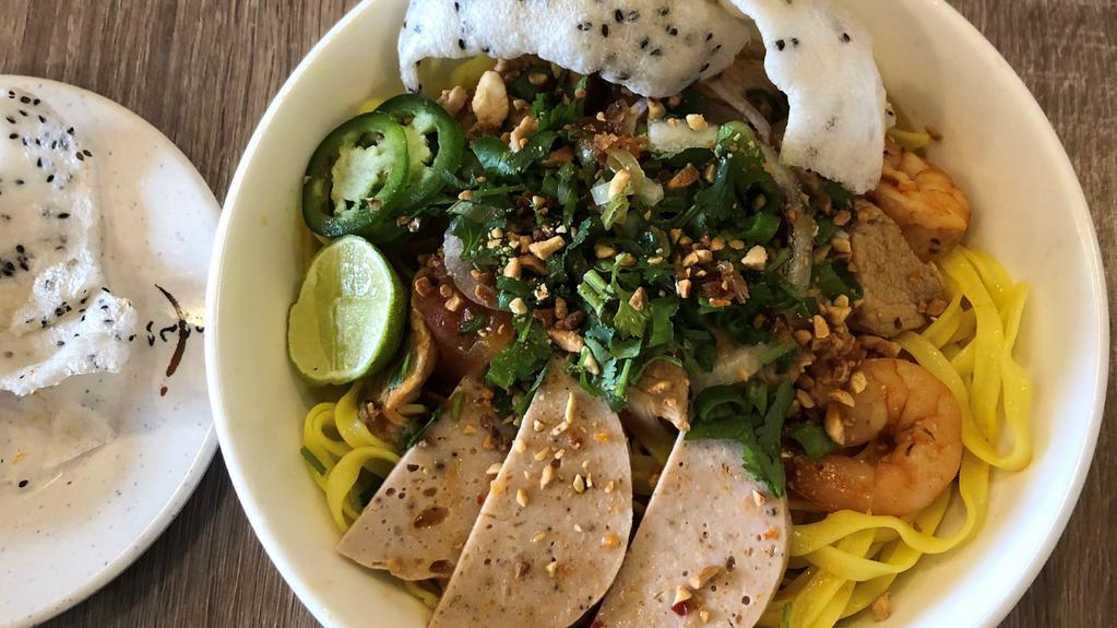 Mì Quãng · Quang's turmeric yellow noodle soup with shrimp and pork.