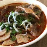 Bún Bò Huế + Đuôi Bò · Hue's spicy noodle soup + oxtail.