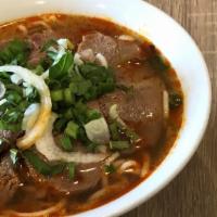 Bún Bò Huế Thịt Bò Tái · Sliced thin rare filet mignon in spicy noodle soup.