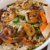 Bún Tôm Nướng Chả Giò · Grilled shrimp and egg roll over vermicelli and vegetables.