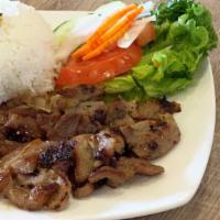 Cơm Thịt Nướng · Grilled sliced pork with steamed rice and vegetables.