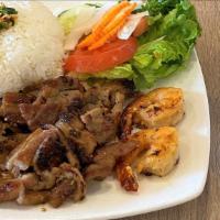Cơm Tôm  Thịt Nướng · Grilled sliced pork and shrimp with steamed rice and vegetables.