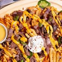 Philly Fries · Fries with choice of meat, GameDay cheese sauce, bell peppers, mushrooms, and caramelized on...