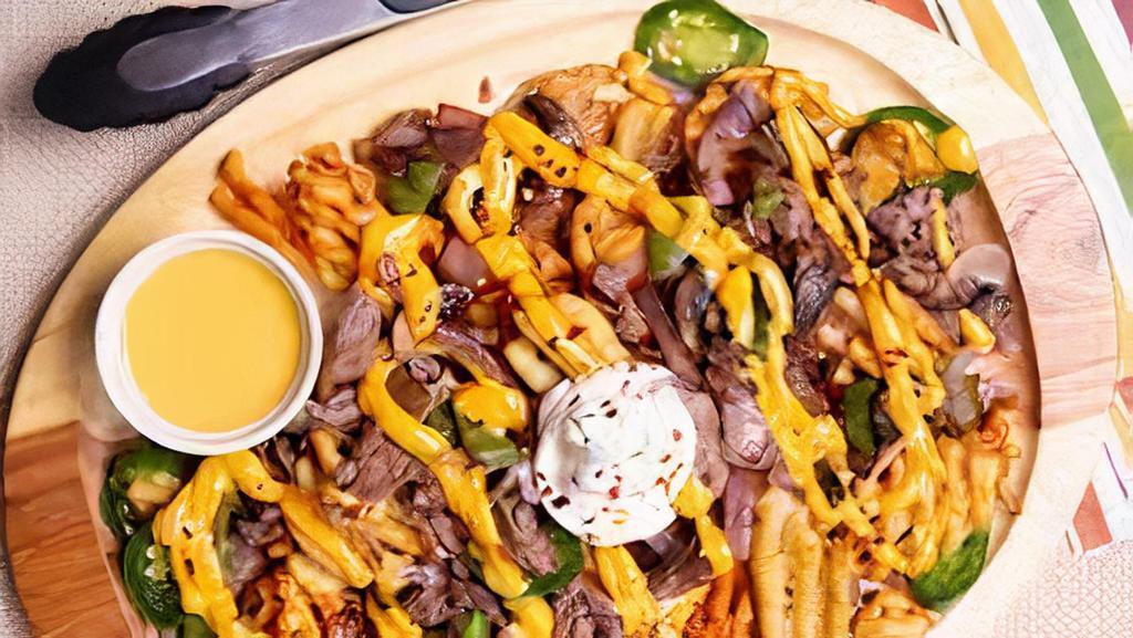 Philly Fries · Fries with choice of meat, GameDay cheese sauce, bell peppers, mushrooms, and caramelized onions.