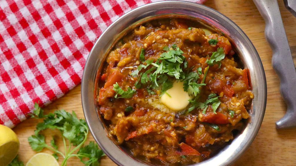 Baingan Bhartha · Baked eggplant  mashed and sauteed with onions, tomato and spices.
