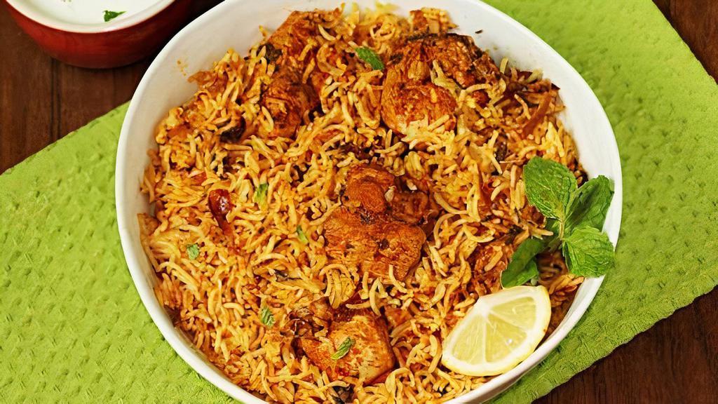 Chicken Biryani · Chicken sauteed with mild spices & herbs, cooked with basmati rice, garnished with fried onions & golden egg.