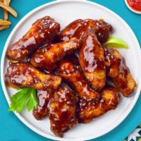 BBQ Smokehouse Wings · Fresh chicken wings breaded, fried until golden brown, and tossed in hickory smoked barbecue...