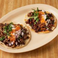 Tacos · Soft corn tortillas, meat, cilantro, onion, salsa, meat or fish.