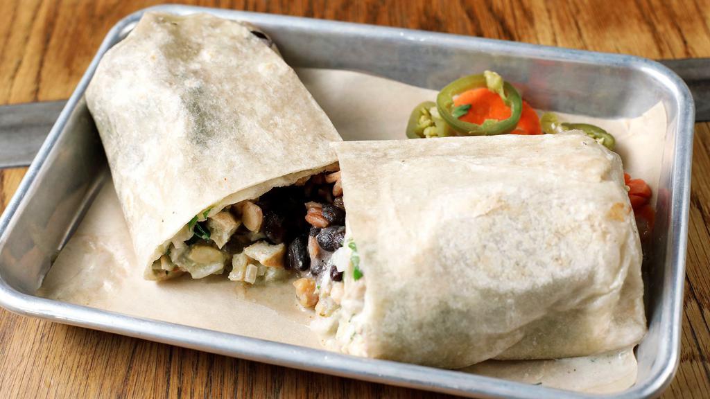 TOFU CHILE VERDE BURRITO · Tofu chile verde, garbanzo beans, roasted green chiles, black beans, red rice, cheese, crema, onions, cilantro. *Tofu and garbanzo beans cannot be separated
