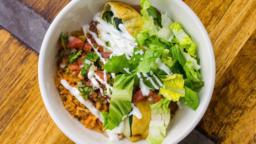 CHILE RELLENO BOWL · Batter-fried cheese-stuffed pasilla chile, refried pinquito beans(not vegetarian), red rice, lettuce, crema, pico de gallo