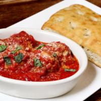 Patxi's Meatballs · Home-made meatballs braised with tomato sauce, parmesan, and basil, in a bread bowl.