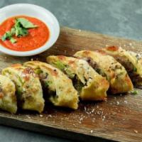 Patxi's Sausage Roll · Garlic-fennel sausage, bell peppers, red onion, and mozzarella rolled in rosemary parmesan d...