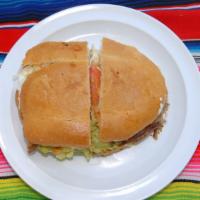 Torta Mexicana · Mexican bread, refried beans, cheese, guacamole, sour cream, lettuce, tomato, jalapeño peppe...