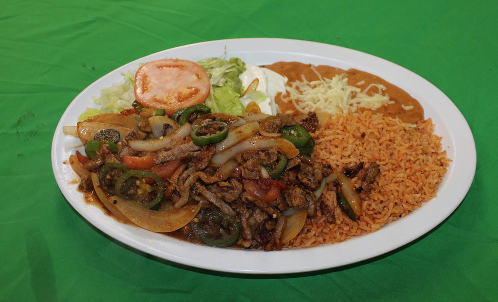 Bisteck Ranchero · steal strips sautéed with jalapeno peppers, onions, tomato and bell peppers. Served with rice refried beans, lettuce , sour cream, guacamole and flour or corn tortillas.