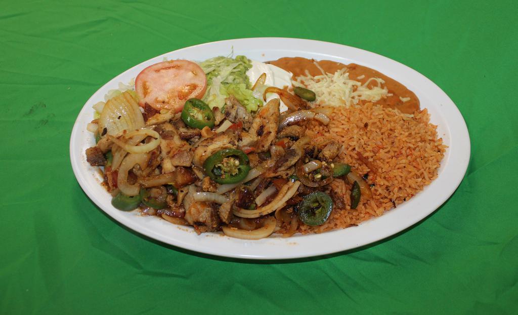 Pollo Ranchero · chicken strips sauteed with jalapeno peppers, onions, tomato and  a special tomatillo sauce. Served with rice, refried beans, lettuce, guacamole , sour cream and flour or corn tortillas