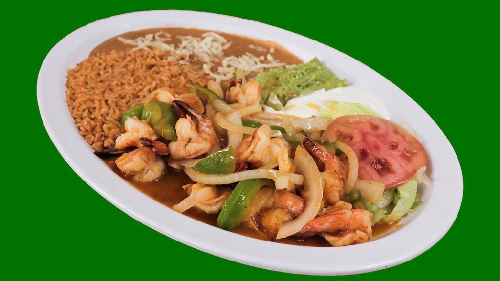 Fajitas Marinas · Seafood fajitas: grilled shrimp sauteed with onions, tomatoes and bell peppers. Served with rice, refried beans, lettuce, sour cream, guacamole, with the choice of corn or flour tortillas.