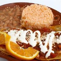 Huevos Rancheros · Two lightly fried corn tortillas with two fried eggs and ranchera sauce. Served with beans.