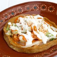 Sope · Thick handmade corn tortilla with pinched edges. Topped with beans, lettuce, salsa, cream an...