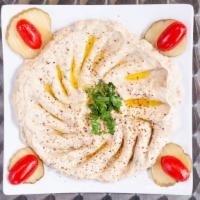 Baba Ganoush · Smoked roasted eggplant blend with garlic tahini. Lemon and a touch of olive oil.