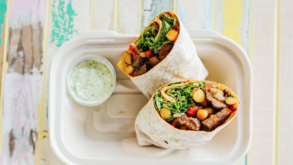 Butcher's Kofte (Meatball) Wrap · Roasted ground lamb and beef shoulder balls, chickpea salad with red pepper and onion, fresh herb yogurt sauce and arugula wrapped in warm and freshly made lavash with pepper paste. Comes with fresh herb yogurt sauce and hot sauce. *Contains dairy and gluten.