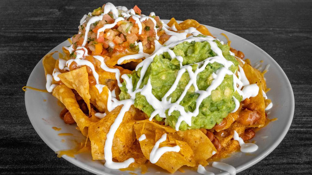 Nachos · Tortilla chips, pinto beans, melted cheese, salsa  fresca,  guacamole and sour cream.

Protein options available with additional charge.