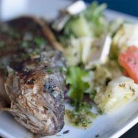 Whole Lavraki · Mediterranean sea bass grilled with rice, vegetables, and house dressing.