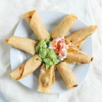 FLAUTAS · Crispy corn tortillas filled with your choice of chicken, shredded beefor combo. Topped wit...