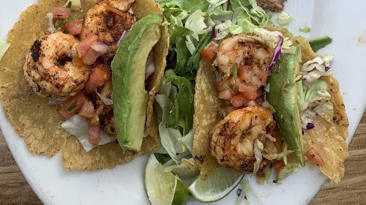 SHRIMP TACOS · Sautéed spicy shrimp in hand-crafted multi-grain tortillas with chipotlecream, lettuce, salsa fresca and avocado.