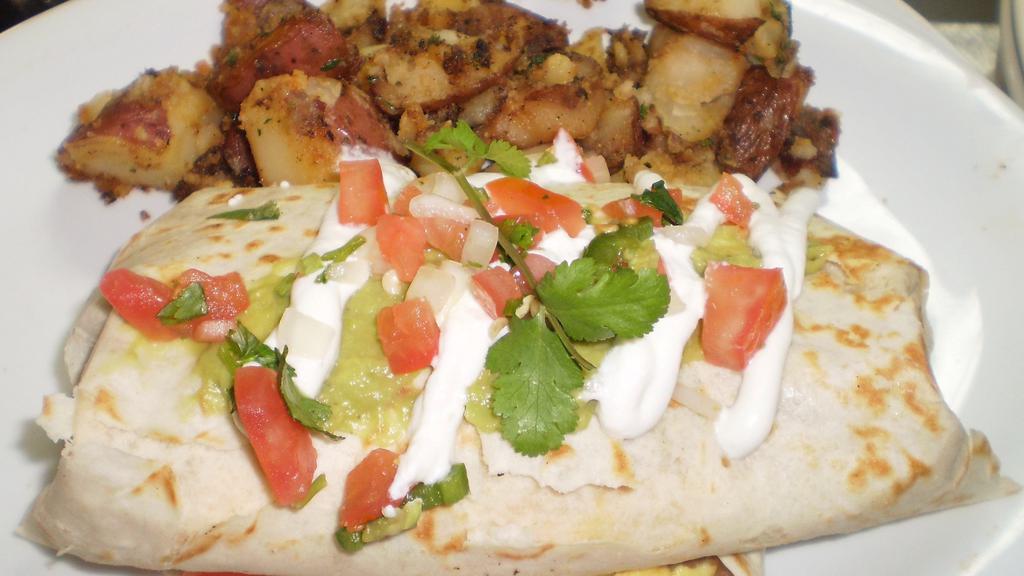 Breakfast Burrito · Tortilla stuffed with scrambled eggs, tomatoes, bell peppers, onions, refried beans and jack cheese. Topped with guacamole, sour cream and salsa.