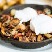Corned Beef Hash´N Eggs · Homemade with diced potatoes, onions, mushrooms, topped with two poached eggs. Toast and cou...