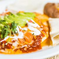 Huevos Rancheros · Three eggs simmered in salsa, served with refried beans, sour cream and tortillas.