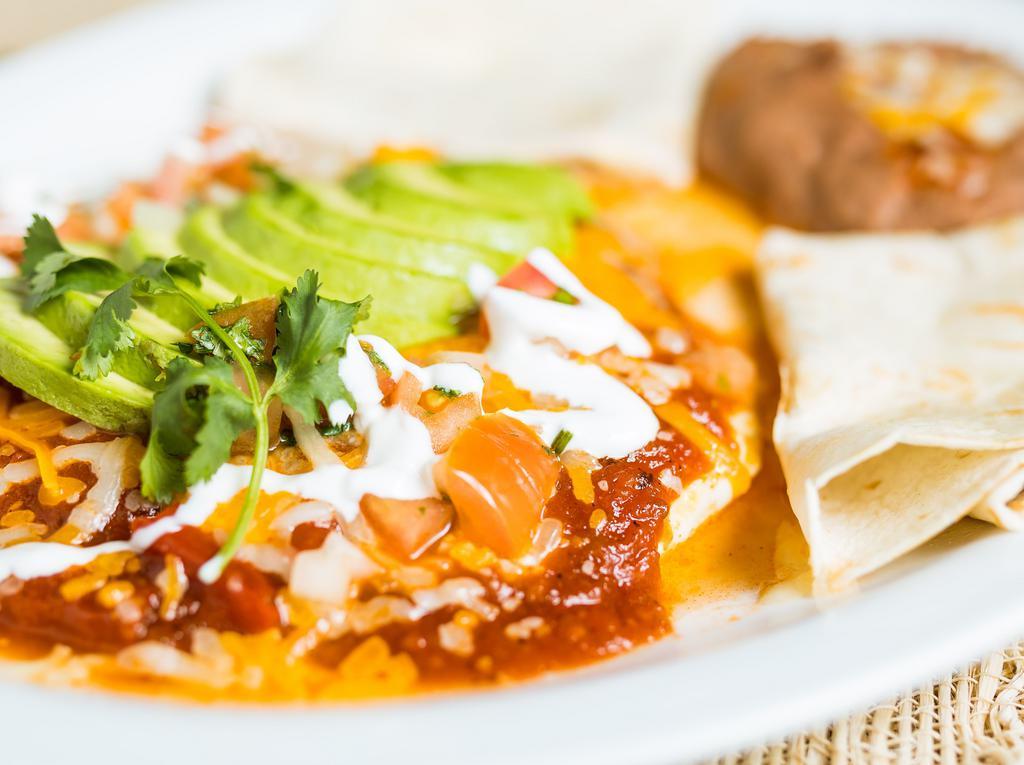 Huevos Rancheros · Three eggs simmered in salsa, served with refried beans, sour cream and tortillas.
