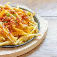 Bacon Cheese Fries · Deep fried golden crisp fries topped with melted yellow cheese and crunchy bacon bits.