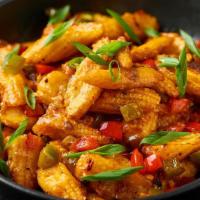 Baby Corn Manchurian · Batter fried baby corn pieces tossed and coated in tangy garlic sauce.