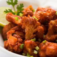 Gobi Manchurian · Batter fried cauliflower pieces tossed and coated in tangy garlic sauce.
