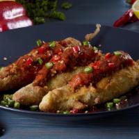 Stuffed Mirchi · Long hot peppers battered, stuffed with onions and tomatoes.