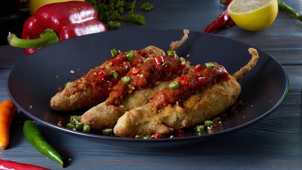 Stuffed Mirchi · Long hot peppers battered, stuffed with onions and tomatoes.